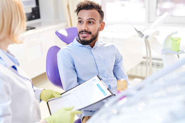 a man sitting in a dental chair for a dental checkup